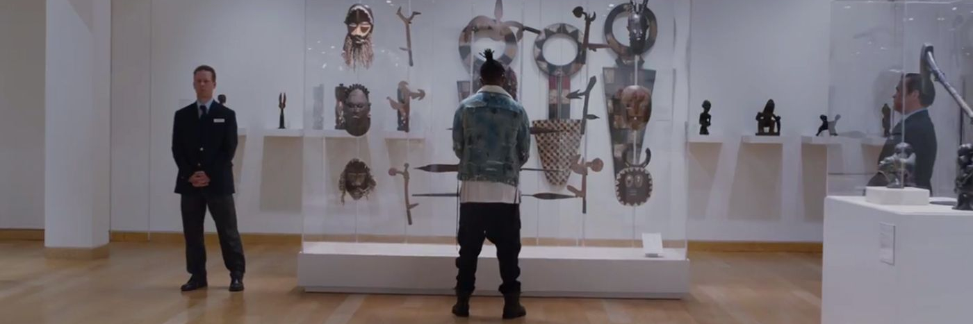 Killmonger in front of a case of artefacts at a museum